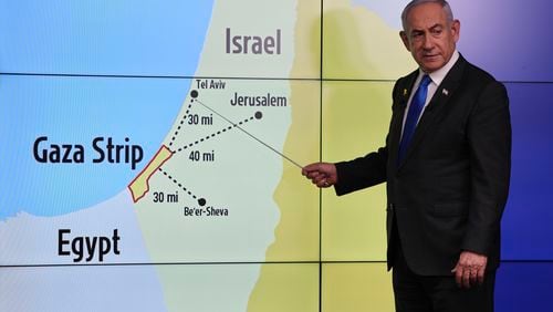 Israeli Prime Minister Benjamin Netanyahu gestures in front of a map during a press conference at the Government Press office in Jerusalem, Wednesday, Sept. 4, 2024. (Abir Sultan/Pool via AP)