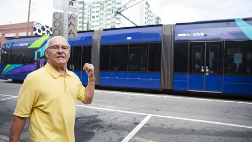 Fred Duncan, an Old Fourth Ward resident, watches the Atlanta Streetcar pass on Nov. 7. Duncan opposes a proposed expansion of the streetcar to Ponce City Market. CHRISTINA MATACOTTA FOR THE ATLANTA JOURNAL-CONSTITUTION.