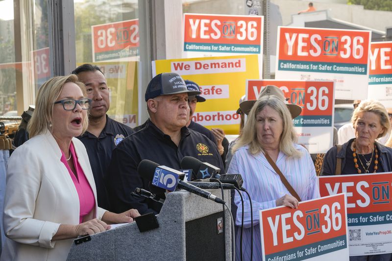 Los Angeles City Council member Traci Park, at podium left, is joined by United Firefighters of Los Angeles City President Local 112, President Freddy Escobar, third from left, with a coalition of Los Angeles area elected leaders, public safety officials and business leaders to announce their support for Proposition 36 on the November ballot at a news conference in the Venice neighborhood in Los Angeles, on Monday, Sept. 30, 2024. (AP Photo/Damian Dovarganes)