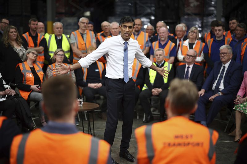 Britain's Prime Minister and Conservative Party leader Rishi Sunak holds a Q&A with staff of a West William distribution centre in Ilkeston in the East Midlands, Britain, Thursday, May 23, 2024 as part of a campaign event ahead of a general election on July 4. Britain’s political party leaders were crisscrossing the country on Thursday, the first day of a six-week election campaign in which voters will decide whether to end the governing Conservatives’ 14 years in power. (HENRY NICHOLLS/Pool photo via AP)