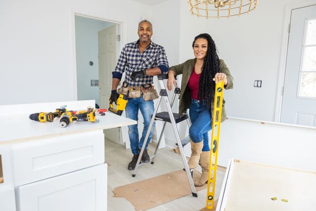 As seen on "Married to Real Estate," hosts Mike Jackson and Egypt Sherrod work together to finish cabinets and design elements in a completely renovated kitchen for a homeowner.