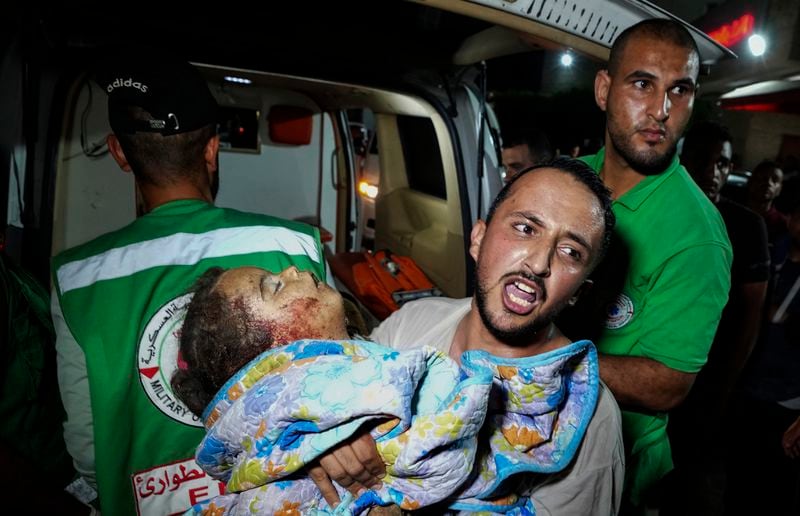 EDS NOTE: GRAPHIC CONTENT - A Palestinian relative moves a child of Rewan Ghanem killed in an Israeli bombardment on a residential building owned by the Ghanem family in Bureij refugee camp, at al-Aqsa Martyrs hospital in Deir al-Balah, central Gaza Strip, late Monday, June 3, 2024. (AP Photo/Abdel Kareem Hana)
