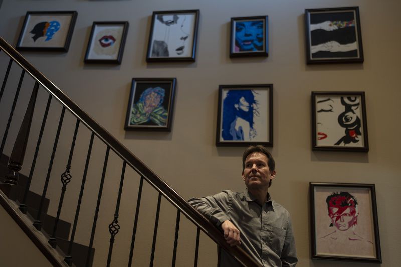 Matt Capelouto, whose daughter, Alexandra, died from a fentanyl overdose, stands for a photo in front of a wall decorated with his daughter's artworks in Temecula, Calif., Tuesday, Sept. 17, 2024. (AP Photo/Jae C. Hong)