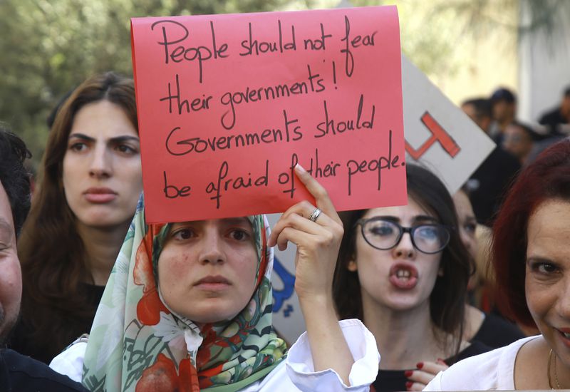 Members of the opposition and civil society groups shout slogans and wave placards during a demonstration against Tunisia president Kais Saied, ahead of the upcoming presidential elections, in Tunis, Friday, Sept. 27, 2024. (AP Photo/Anis Mili)