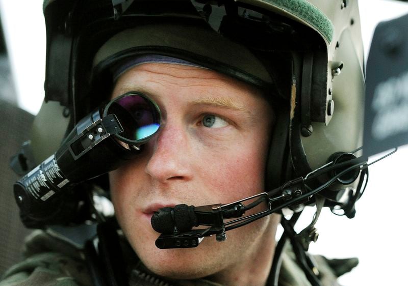 FILE - Britain's Prince Harry or just plain Captain Wales as he is known in the British Army, wears his monocle gun sight as he sits in the front seat of his cockpit at the British controlled flight-line in Camp Bastion southern Afghanistan, Dec. 12, 2012. (AP Photo/ John Stillwell, File)