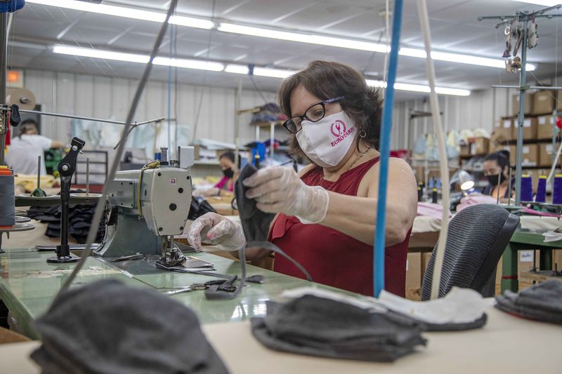 Eurotard Dancewear employee Orfelia Mendez sews together pieces of a face mask at the manufacturer's building in Alpharetta on Sept. 3, 2020. (Alyssa Pointer / Alyssa.Pointer@ajc.com)