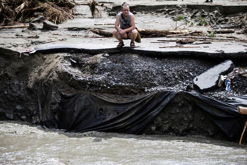 An overwhelmed residents surveys the damage following flooding caused by the remnants of Hurricane Beryl, Thursday, July 11, 2024, in Plainfield, Vt. (AP Photo/Dmitry Belyakov)