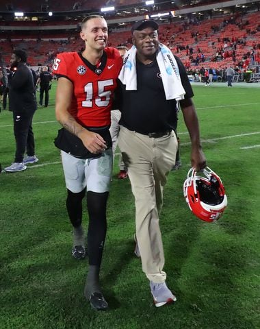 Georgia quarterback Carson Beck is all smiles walking off the field with Bryant Gantt, Director of Player Support and Operations, after beating Kentucky 51-13 in a NCAA college football game on Saturday, Oct. 7, 2023, in Athens.  Curtis Compton for the Atlanta Journal Constitution