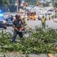 Workers clean up fallen tree on Roswell Road north of Dalrymple after Hurricane Idalia hits Georgia.