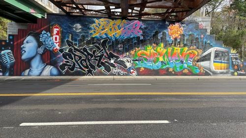 A wall showcases pieces done by Atlanta graffiti artists SAVE and Sparky Z for the 2023 ATL Jam.