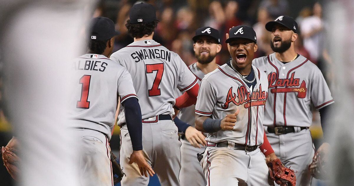 The Braves' Dansby Swanson high fives teammates prior to a game against the  Arizona Diamondbacks on Monday, Aug…