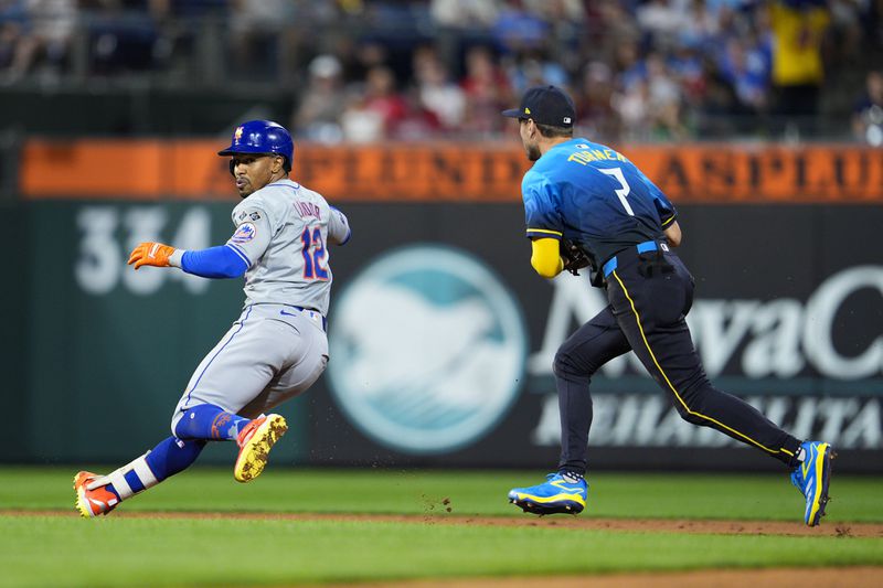 New York Mets' Francisco Lindor, left, is tagged out by Philadelphia Phillies' Trea Turner (7) after trying to advance to third base during the sixth inning of a baseball game, Friday, Sept. 13, 2024, in Philadelphia. (AP Photo/Derik Hamilton)