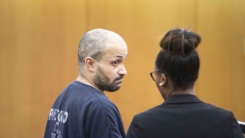 Christopher Clemons listens to his attorney during a plea in the courtroom of Thomas A. Cox, Jr. at Fulton County Superior Court on Tuesday, Jan. 23. ALYSSA POINTER/ALYSSA.POINTER@AJC.COM