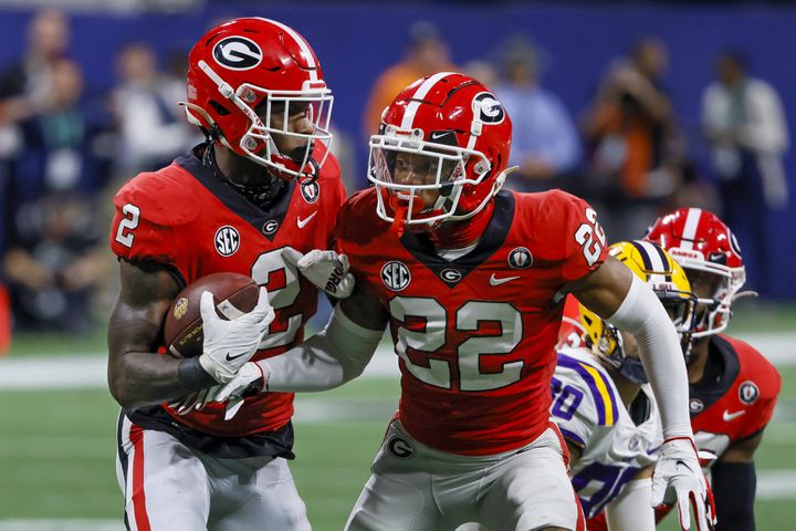 Georgia Bulldogs linebacker Smael Mondon Jr. (2) recovers a deflected LSU Tigers pass with defensive back Javon Bullard (22) during the first half of the SEC Championship Game at Mercedes-Benz Stadium in Atlanta on Saturday, Dec. 3, 2022. (Bob Andres / Bob Andres for the Atlanta Constitution)