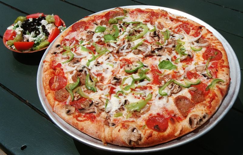 Mo's Pizza on Briarcliff Road in Atlanta has been around since 1979. Pictured are Mo's deluxe pizza and a Greek salad. Atlanta Journal-Constitution file