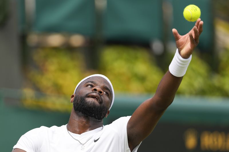 Frances Tiafoe of the United States serves to Borna Coric of Croatia during their match on day three at the Wimbledon tennis championships in London, Wednesday, July 3, 2024. (AP Photo/Alberto Pezzali)