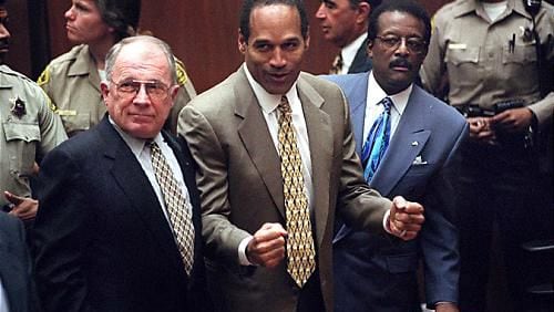 O.J. Simpson reacts as he is found not guilty of murdering his ex-wife Nicole Brown Simpson and her friend Ron Goldman at the Criminal Courts Building in Los Angeles on Oct. 3, 1995. At left is defense lawyer F. Lee Bailey and at right, defense attorney Johnnie Cochran Jr. Defense attorney Robert Shapiro is in profile behind them. Bailey died Thursday in Georgia.