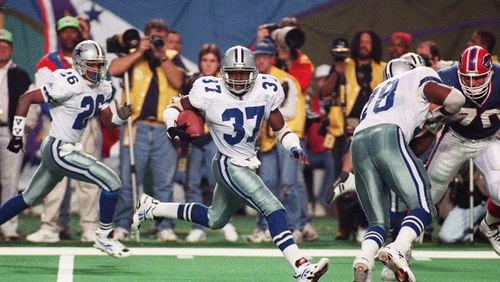 FILE - Dallas Cowboys safety James Washington (37) sprints to a touchdown after Buffalo Bills' Thurman Thomas fumbled the ball during third quarter action at Super Bowl XXVIII in the Georgia Dome in Atlanta, Jan. 30, 1994. Washington recovered the fumble and ran 46 yards for the tying touchdown in the second half. (AP Photo/Doug Mills, File)