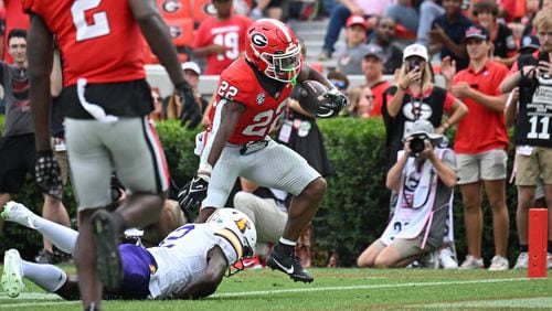 Georgia running back Branson Robinson (22) runs for a touchdown past Tennessee Tech defensive back James Edwards (2) during the second half in an NCAA football game at Sanford Stadium, Saturday, September 9, 2024, in Athens. Georgia won 48-3 over Tennessee Tech. (Hyosub Shin / AJC)