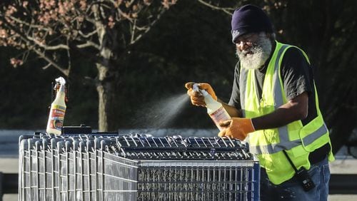 Sam’s Club workers sanitized shopping carts as customers lined up over the length of a football field at Sam’s Club located at 2901 Clairmont Rd in DeKalb County on Friday, April3, 2020. JOHN SPINK/JSPINK@AJC.COM