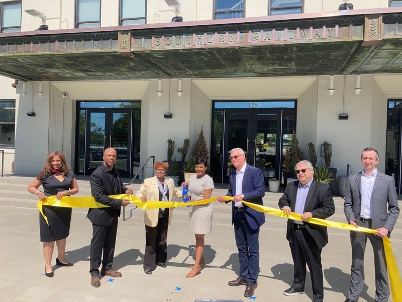 Mayor Keisha Lance Bottoms (center) takes part in a ribbon-cutting for a building of loft-style apartments at Centennial Yards.