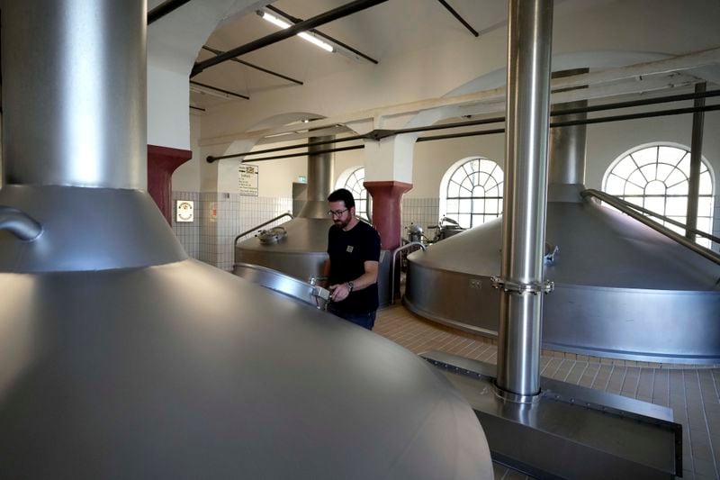 Head Brewmaster Tobias Zollo checks the output at the Weihenstephan brewery in Freising, Germany, Friday, Sept. 20, 2024. (AP Photo/Matthias Schrader)