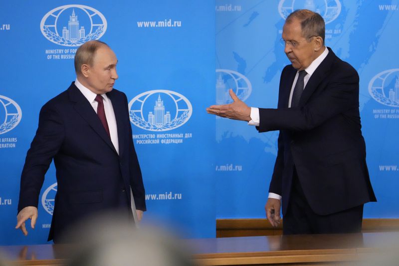 Russian President Vladimir Putin, left, and Russian Foreign Minister Sergey Lavrov arrive to a meeting at the Russian Foreign Ministry in Moscow, Russia, Friday, June 14, 2024. (AP Photo/Alexander Zemlianichenko)