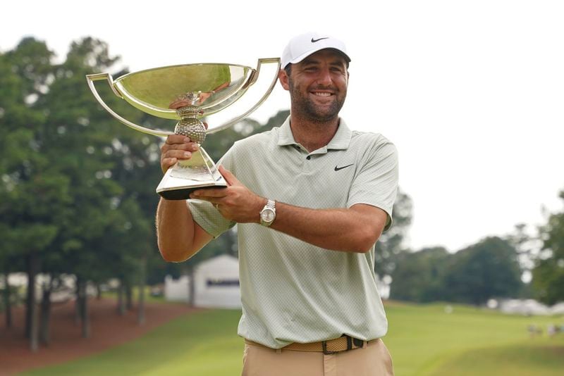 Scottie Scheffler poses with the FedExCup Trophy after the final round of the Tour Championship golf tournament, Sunday, Sept. 1, 2024, in Atlanta. (AP Photo/Jason Allen)