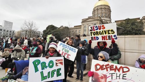 Demonstrators who support abortion rights and others who oppose abortion display their signs in March at the Georgia Capitol in Atlanta. (ALYSSA POINTER/ALYSSA.POINTER@AJC.COM)