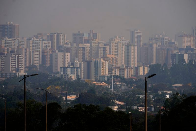 Smoke from fires in the Amazon covers the Aguas Claras neighborhood of Brasilia, Brazil, Sunday, Aug. 25, 2024. (AP Photo/Eraldo Peres)