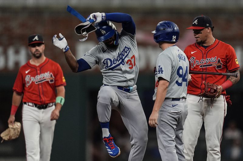 Los Angeles Dodgers' Teoscar Hernández (37) celebrates his double against the Atlanta Braves in the third inning of a baseball game, Friday, Sept. 13, 2024, in Atlanta. (AP Photo/Mike Stewart)