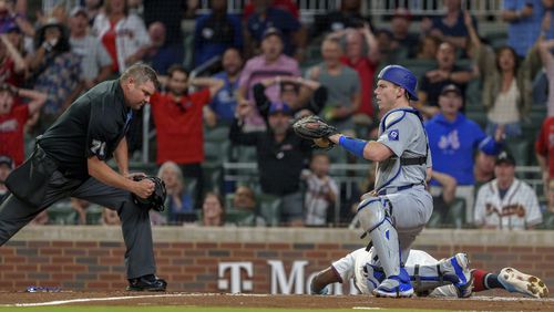 Los Angeles Dodgers catcher Will Smith tags Atlanta Braves' Michael Harris II, right, at home plate in the third inning of a baseball game, Monday, Sept. 16, 2024, in Atlanta. (AP Photo/Jason Allen)