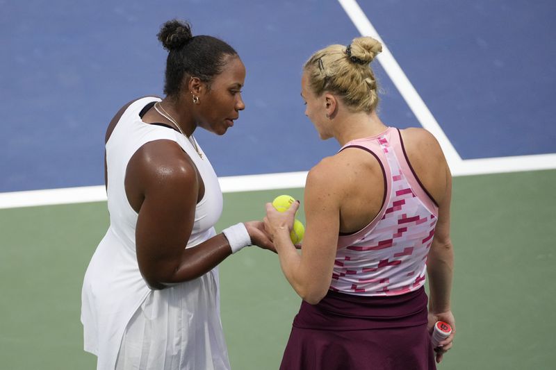 Katerina Siniakova, of the Czech Republic, and Taylor Townsend, of the United States, react during a second round match of the U.S. Open tennis championships, Thursday, Aug. 29, 2024, in New York. (AP Photo/Frank Franklin II)