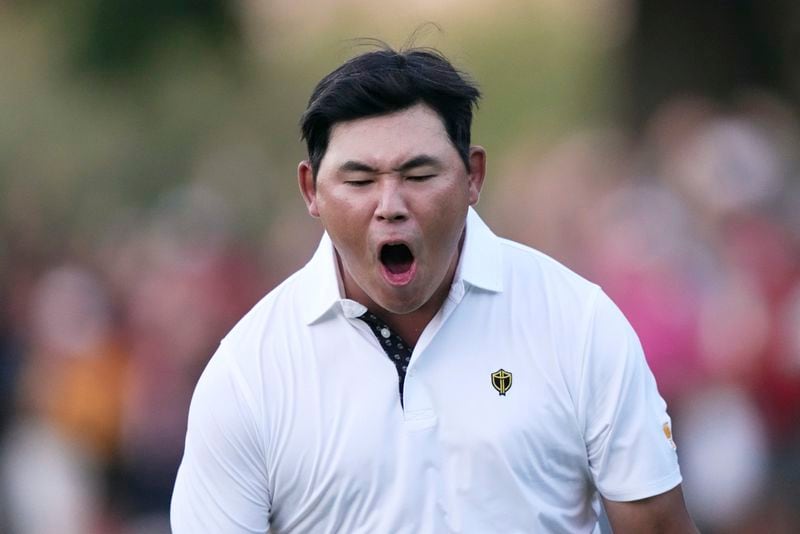 International team member Si Woo Kim of South Korea, celebrates after chipping in to win the 16th hole during their fourth round foursomes match at the Presidents Cup golf tournament at Royal Montreal Golf Club Saturday, September 28, 2024 in Montreal. (Nathan Denette/The Canadian Press via AP)