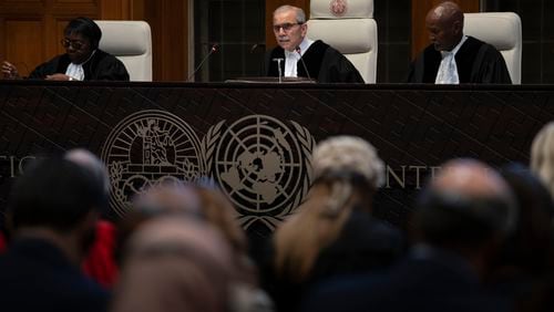 Presiding Judge Nawaf Salam reads the ruling of the International Court of Justice, or World Court, in The Hague, Netherlands, Friday, May 24, 2024, where the top United Nations court ruled on an urgent plea by South Africa for judges to order Israel to halt its military operations in Gaza and withdraw from the enclave. (AP Photo/Peter Dejong)