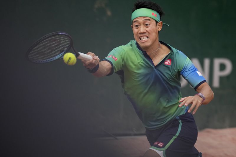 Japan's Kei Nishikori plays a shot against Canada's Gabriel Diallo during their first round match of the French Open tennis tournament at the Roland Garros stadium in Paris, Sunday, May 26, 2024. (AP Photo/Christophe Ena)