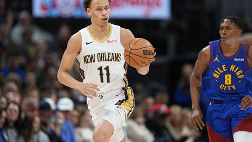 New Orleans Pelicans guard Dyson Daniels, left, pulls in a loose ball as Denver Nuggets forward Peyton Watson pursues in the second half of an NBA basketball game Friday, Jan. 12, 2024, in Denver. (AP Photo/David Zalubowski)