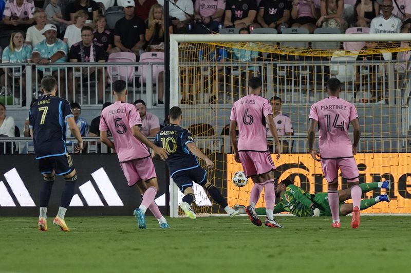 Inter Miami goalkeeper Drake Callender (1) is unable to catch a goal by Philadelphia Union forward Mikael Uhre (7) during the first half of an MLS soccer match, Saturday, Sept. 14, 2024, in Fort Lauderdale, Fla. (AP Photo/Marta Lavandier)