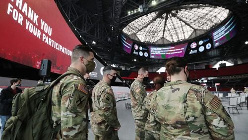 032321 Atlanta: Some of the 222 U.S. Army troops gear up at Mercedes-Benz Stadium as operations get under way for the facility to become the largest Community Vaccination Center in the southeast serving an average of 42,000 citizens a week on Tuesday, March 23, 2021, in Atlanta. There are 202 soldiers from Fort Stewart and twenty U.S. Army medical specialists that will operate some of the vaccination areas located inside Mercedes-Benz Stadium.   “Curtis Compton / Curtis.Compton@ajc.com”
