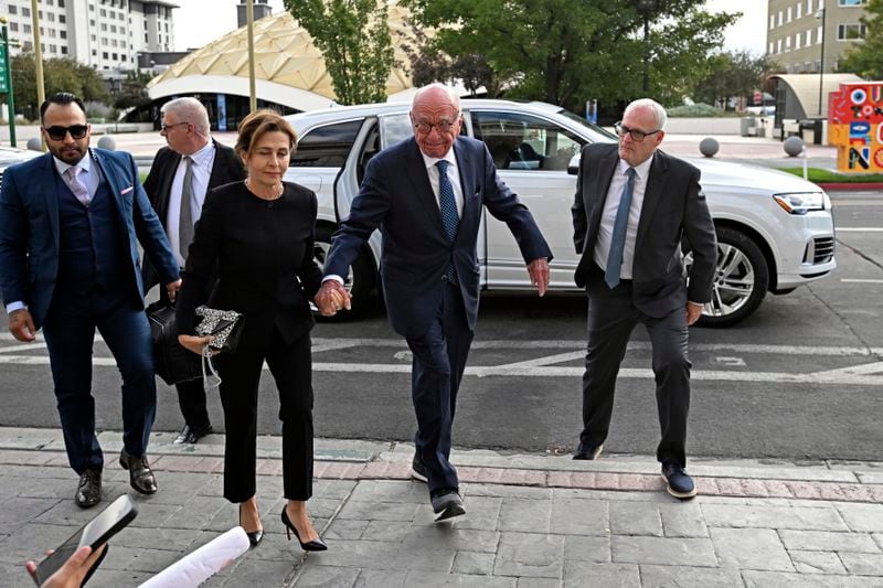 Rupert Murdoch, center, and his wife Elena Zhukova Murdoch arrive at the Second Judicial District Court in Reno, Nev., Monday Sept. 16, 2024. (AP Photo/Andy Barron)