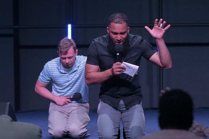 Josh Clemons (right) and Hazen Stevens, co-directors of OneRace, pray together for racial reconciliation. 