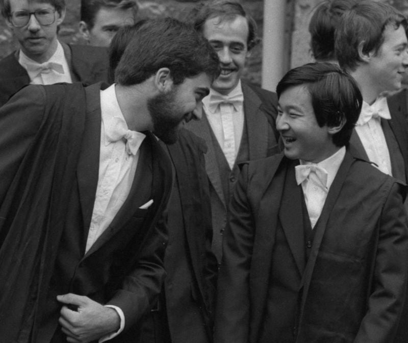 FILE - Japan's Prince Hiro, right, talks with a fellow student at Oxford University when he and other students were welcomed to the university at a matriculation ceremony, on Oct. 15, 1983. Naruhito and the Empress Masako, who studied at Oxford a few years after her husband, wrapped up a weeklong trip to Britain on Friday. Their itinerary combined the glitter and ceremony of a state visit with four days of less formal events that gave the royal couple an opportunity to revisit their personal connections to Britain. (AP Photo/Peter Kemp, File)