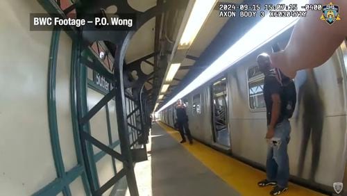 In this image from video provided by the New York Police Department, officers point their weapons towards Derell Mickles at the Sutter Avenue subway station in the Brownsville neighborhood of the Brooklyn borough of New York, on Sunday, Sept. 15, 2024. (NYPD via AP)