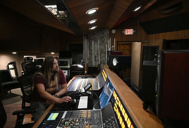 Tour guide Matthew Lang at the controls in the original studio at Capricorn Studios at 530 Martin Luther King Jr. Blvd in downtown Macon. (Hyosub Shin / AJC)