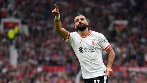 Liverpool's Mohamed Salah celebrates after scoring his side's third goal during the English Premier League soccer match between Manchester United and Liverpool at Old Trafford, Sunday, Sept. 1, 2024, in Manchester, England. (AP Photo/Dave Thompson)