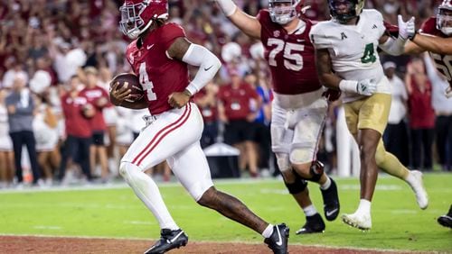 Alabama quarterback Jalen Milroe (4) runs the ball for his second rushing touchdown of the game against South Florida, during the first half of an NCAA college football game, Saturday, Sept. 7, 2024, in Tuscaloosa, Ala. (AP Photo/Vasha Hunt)