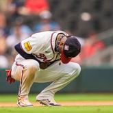 Atlanta Braves second baseman Ozzie Albies holds his wrist after an injury in the eighth inning of a baseball game against the St. Louis Cardinals, Sunday, July 21, 2024, in Atlanta. (AP Photo/Jason Allen)