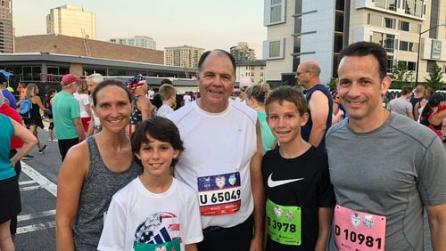 Lance Brady (center) and his daughter Meredith McKee at the 2018 AJC Peachtree Road Race. With them are Meredith's husband, Scott McKee (far right). With them are the McKee's sons, Nathan (left) and Ryan (right). The Brady family has made the Peachtree Road Race a family event since the 1980s. (Photo contributed by Brady family)