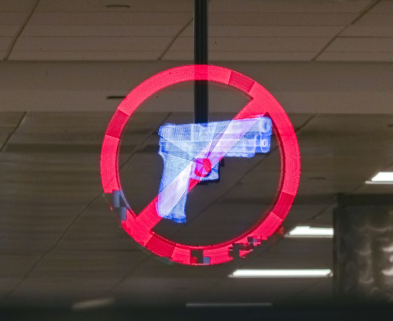 April 1, 2022: Hartsfield-Jackson International Airport: A Hologram displays no weapons at the security gate at Hartsfield-Jackson International Airport  (John Spink / John.Spink@ajc.com)

