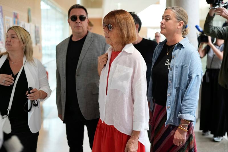 Gisele Pelicot, center, arrives in the Avignon court house, in Avignon, southern France, Thursday, Sept. 5, 2024. A woman allegedly drugged by her ex-husband so that she could be raped by other men while she laid unconscious, is expected to testify before a panel of French judges. (AP Photo/Lewis Joly)